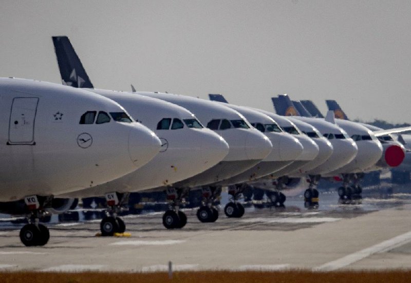 Lufthansa jets are parked on a runway at the airport in Frankfurt, Germany, as the pandemic has all but halted Lufthansa’s business.
(AP/Michael Probst)