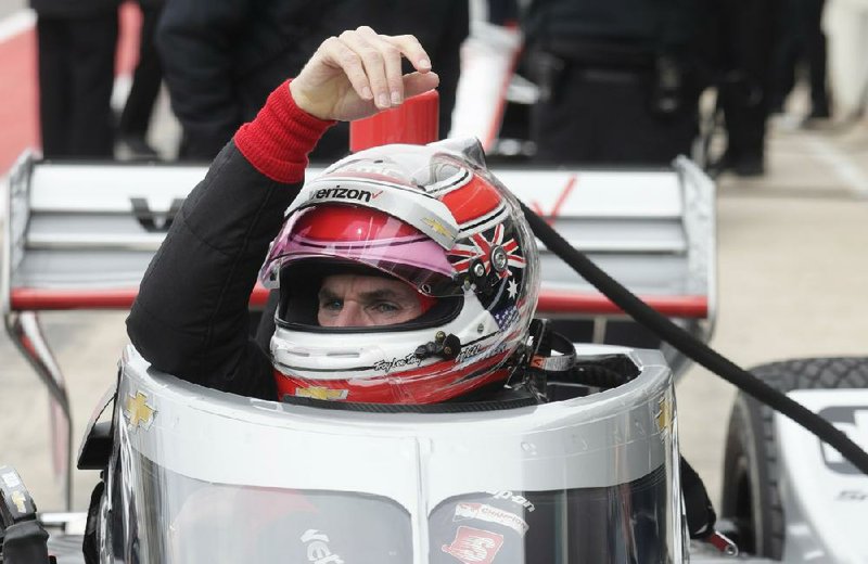 Will Power lowers into his car as he prepares to drive in IndyCar Series testing in February. The series gets its season underway today at Texas Motor Speedway in Fort Worth, where drivers will test a heavy new windshield designed to protect the cockpit.
(AP/Eric Gay)