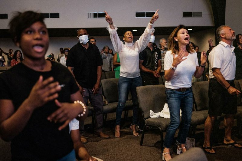 Churchgoers worship at the New Season church in Sacramento, Calif. More than half of the states have continued to allow religious gatherings, but many churches, synagogues and mosques, for safety’s sake, have chosen for months to make do with Zoom sermons and livestreams.
(The New York Times/Max Whittaker)