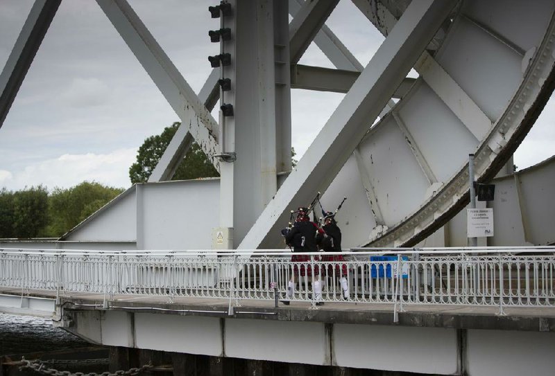 Two bagpipers on Friday cross the WWII Pegasus Bridge, which was built in 1994 on the site of the original bridge in Benouville in Normandy, France.
(AP/Virginia Mayo)