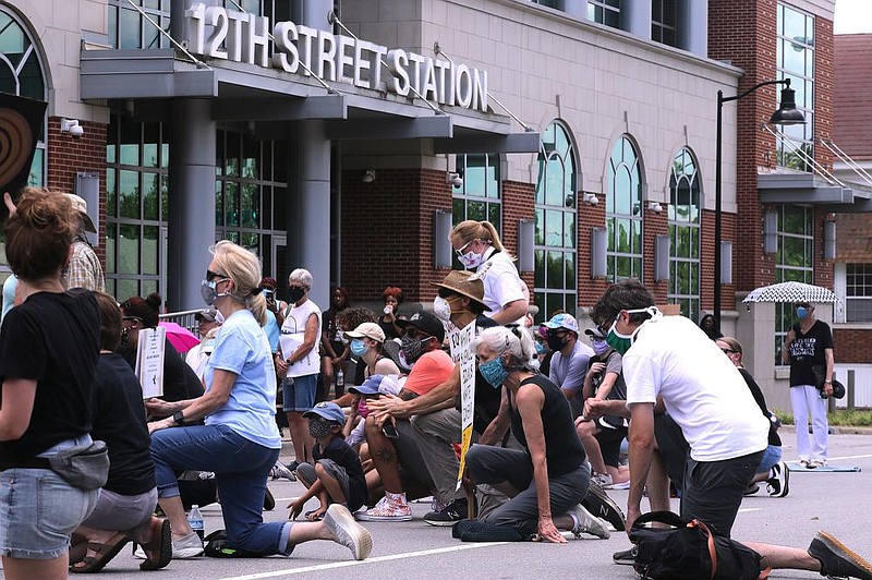 Protesters take a knee outside the Little Rock Police Department's 12th Street Station during the Take a Knee - Rally for Justice on Saturday, June 6, 2020, in Little Rock. 
(Arkansas Democrat-Gazette/Thomas Metthe)