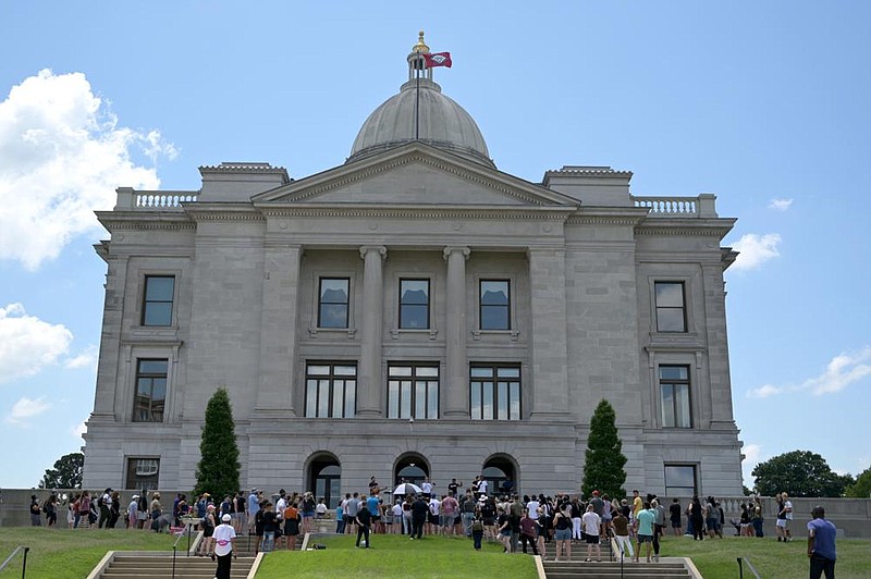 People from New Life Church gather on the side of the state Capitol in Little Rock during a protest over the killing of George Floyd on Sunday, June 7, 2020. Protesters sang songs of praise and observed a moment of silence.