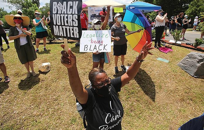 In Little Rock on Saturday, Rhonda Coleman holds up a sign while listening to speakers during a Take a Knee — Rally for Justice event. Demonstrations in Little Rock on Saturday were peaceful. More photos at arkansasonline.com/67rally/.
(Arkansas Democrat-Gazette/Thomas Metthe)