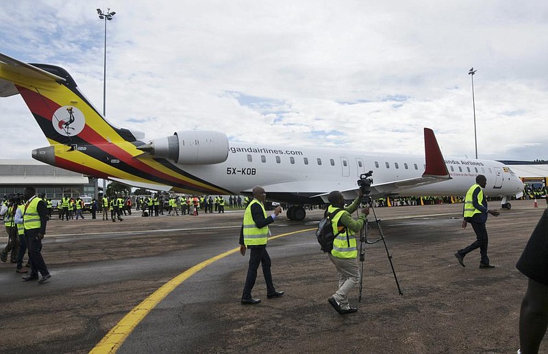 Cameramen film at a ceremony to mark the arrival in April of two CRJ-900 jets from Canadian aerospace company Bombardier for Uganda’s national carrier Uganda Airlines at the airport in Entebbe.
(AP/Ronald Kabuubi)