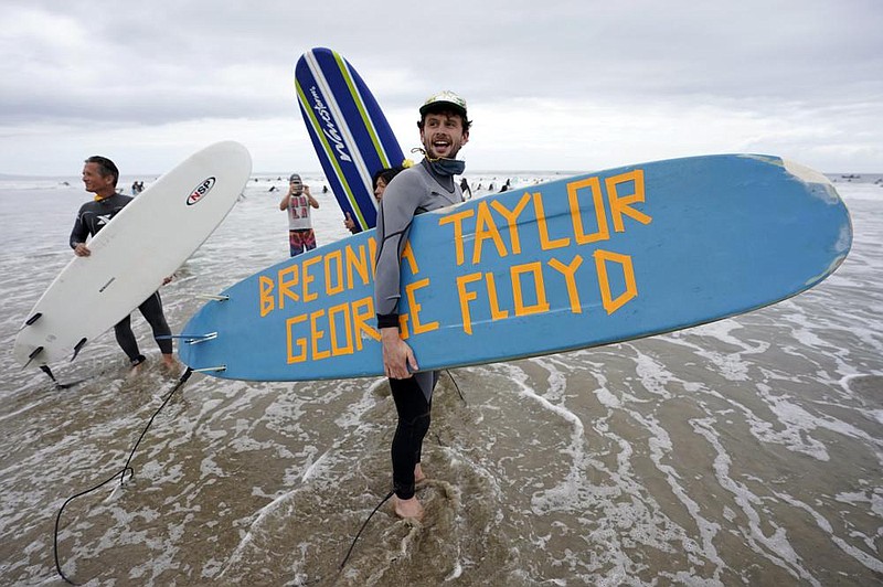 Surfers participate in a paddle out ceremony at “The Ink Well,” a beach historically known as a surfing refuge for black people, to honor the life of George Floyd on Friday in Santa Monica, Calif. (AP/Ashley Landis) 
