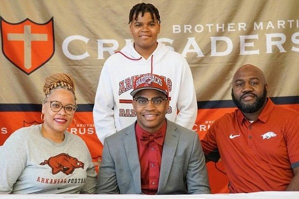 Cornerback Nick Turner (lower middle) poses for a picture with his family after signing his letter of intent to play for the University of Arkansas. Turner has seen the seriousness of the coronavirus pandemic because his mother, Nichole (lower left), is an emer- gency room nurse at a hospital in the New Orleans area. (Submitted photo)