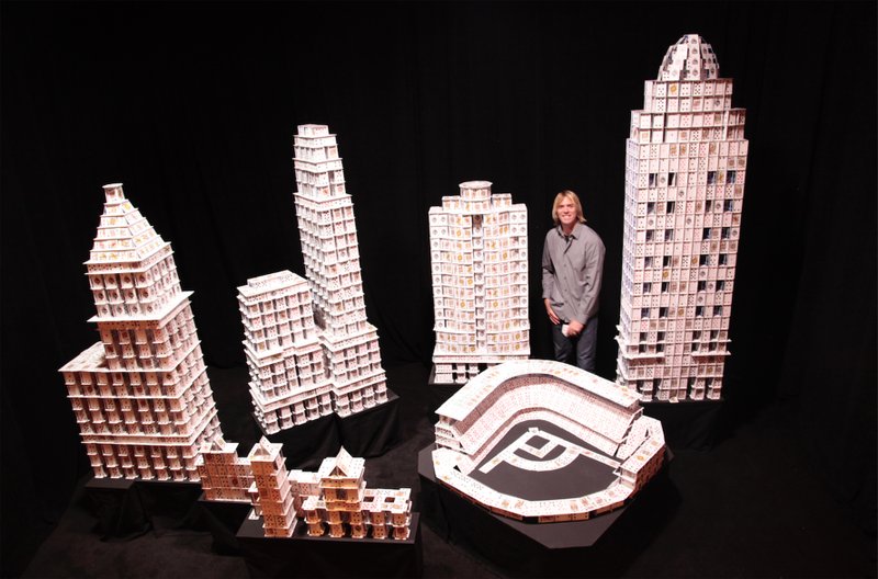 Bryan Berg, posing here with models of landmarks in Cincinnati, says anyone can create structures from cards. (Photo courtesy Bryan Berg) story.lead_photo.caption