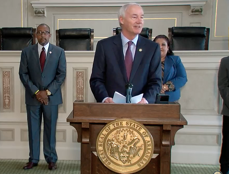 Arkansas Gov. Asa Hutchinson speaks to reporters in Little Rock on Tuesday in this still taken from video provided by the governor's office. 