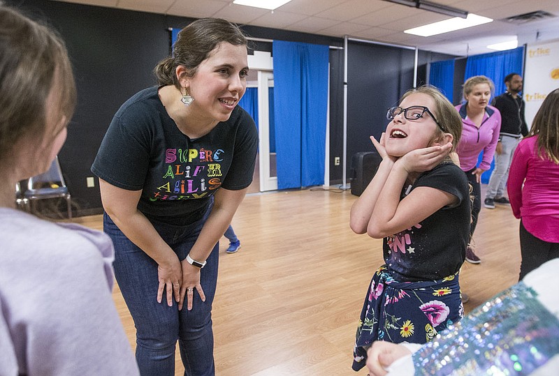 Rachel Bland, a teaching artist with Trike Theatre, works with Bridget Davis of Bella Vista on a choreography exercise during a previous day camp in Bentonville. To alleviate covid-19 concerns, the theater will offer online camps for children of all ages starting June 22.

(NWA Democrat-Gazette/Ben Goff)