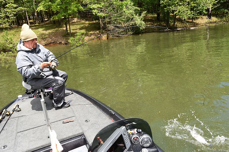 FILE -- Bob Carnes of Rogers wrangles a good-sized crappie toward his boat while fishing May 8, 2020, at Beaver Lake near Horseshoe Bend park.
(NWA Democrat-Gazette/Flip Putthoff)