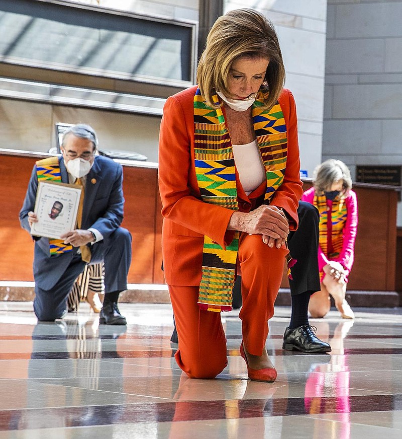 House Speaker Nancy Pelosi and other members of Congress kneel and observe a moment of silence Monday at the Capitol’s Emanci- pation Hall in memory of George Floyd and others who died during police interactions. More photos at arkansasonline.com/69silence/. (AP/Manuel Balce Ceneta) 
