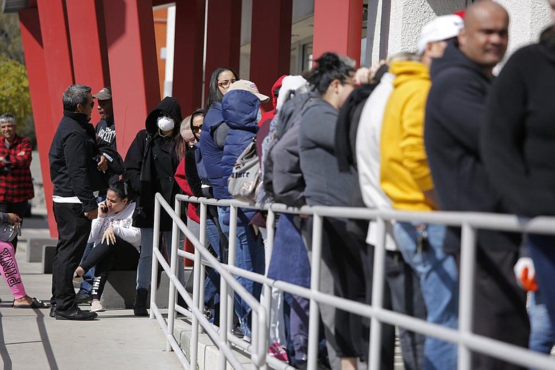 People wait in line for help with unemployment benefits in March at the One-Stop Career Center in Las Vegas. (AP/John Locher) 
