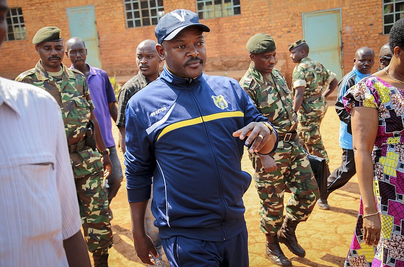 Burundi President Pierre Nkurunziza walks to a polling station to cast his vote for the presidential election in his hometown of Ngozi, Burundi, in this July 21, 2015, file photo. Burundi's government said Tuesday, June 9, 2020, that Nkurunziza has died of a heart attack.