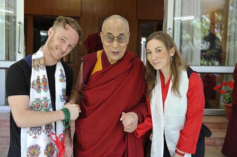 The Dalai Lama poses with Abe Kunin and Junelle Kunin ahead of the Ti- betan spiritual leader’s July 6 release of his first album featuring teachings and mantras set to music. (AP/Office of His Holiness the Dalai Lama) 