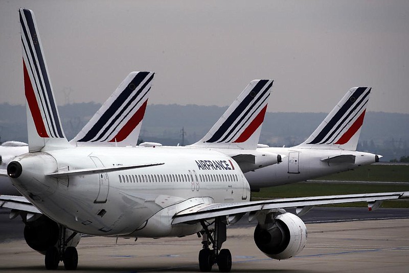 Air France planes sit parked at Paris Charles de Gaulle airport near Paris last month. France’s government has announced $16.9 billion in aid for the virus-battered aerospace industry, including plane-maker Airbus and national airline Air France. (AP) 