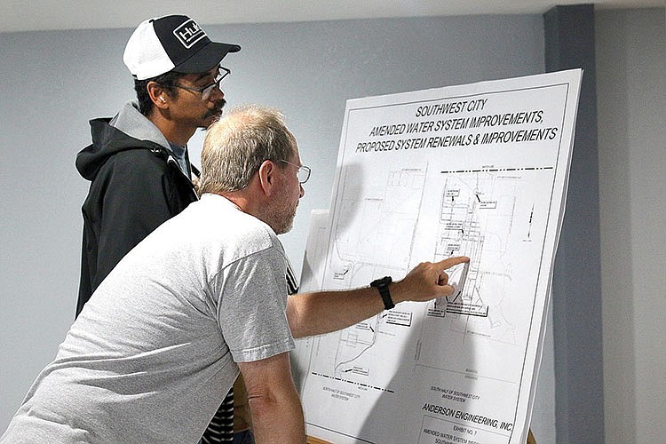 MEGAN DAVIS/MCDONALD COUNTY PRESS Southwest City residents Ron Jackson and Ken Brookner discuss proposed improvements to the city's water system during a second public hearing on Thursday, May 28 - four days before the bond issue was succesfully voted into fruition. 