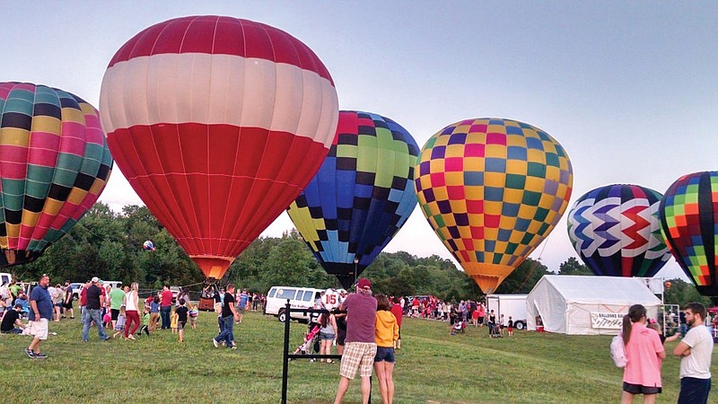 Guests at last year’s Balloons Over Russellville event look at some of the hot-air balloons that are provided by Rodney Williams, owner of Branson Balloons. Williams, originally from the Morrilton area, is supplying the hot-air-balloons for Saturday’s Petit Jean Balloon Event, presented by the organizers of the Petit Jean Farmers’ Market. The hot-air balloon flights have already sold out for the event, but there will be tethered balloon rides and helicopter rides for $20 each.