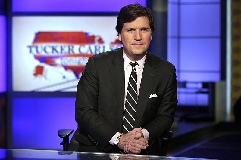 In this March 2, 2017 file photo, Tucker Carlson, host of "Tucker Carlson Tonight," poses for photos in a Fox News Channel studio, in New York.
(AP Photo/Richard Drew, File)