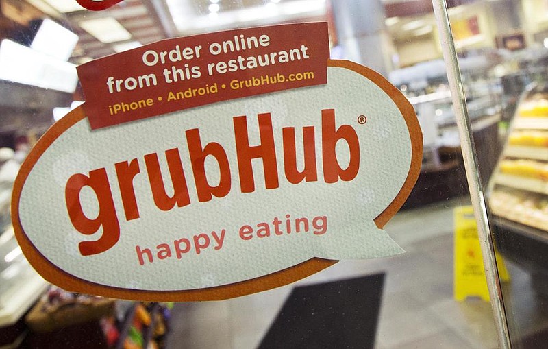 A sign with the old Grubhub logo is displayed on the door to a New York restaurant in this file photo. Just Eat Takeaway.com N.V. has agreed to acquire U.S.-based Grubhub Inc. in an all-stock deal.
(AP)