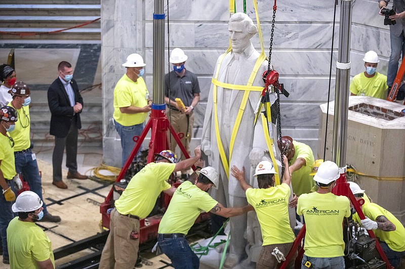 Workers prepare to remove the Jefferson Davis statue from the Kentucky state Capitol in Frankfort, Ky., on Saturday, June 13, 2020. A Kentucky commission voted to take down the statue of the Confederate president, supporting a push from the governor.