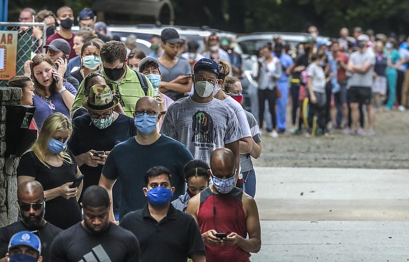 Voters wait in line Tuesday at a polling place in Atlanta. Some said it took up to three hours to cast their ballots, and many said they had requested absentee ballots but never received them.
(The New York Times/Atlanta Journal-Constitution/John Spink/JSPINK@AJC.COM)