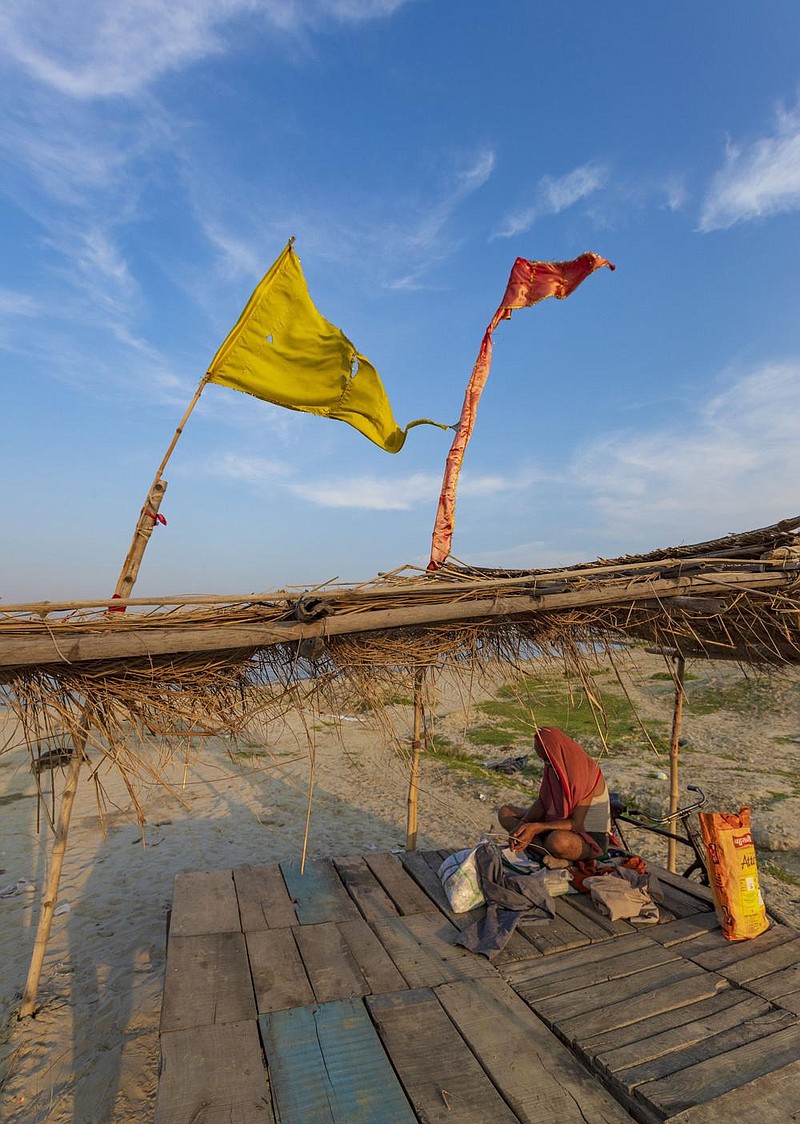 A Hindu holy man performs rituals Friday at the con uence of the Yamuna and Ganges rivers in Prayagraj, India.
(AP/Rajesh Kumar Singh)
story.lead_photo.caption