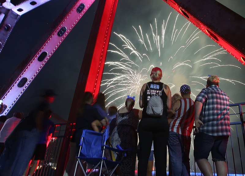 Spectators watch the fireworks finale to the 2019 Pops on the River from the Junction Bridge. (Democrat-Gazette file photo/Thomas Metthe)