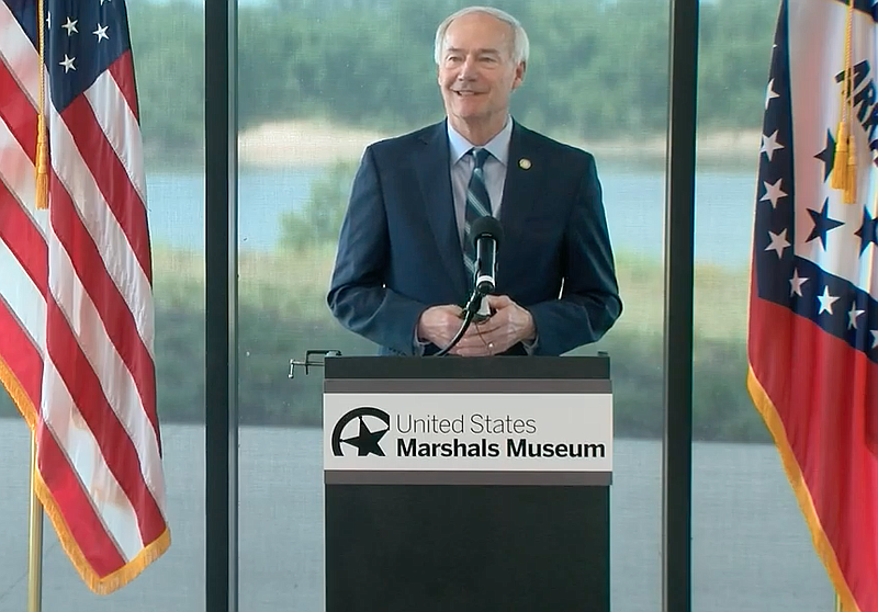Gov. Asa Hutchinson speaks to reporters at the U.S. Marshals Museum in Fort Smith on Thursday in this still captured from video provided by the governor's office. 