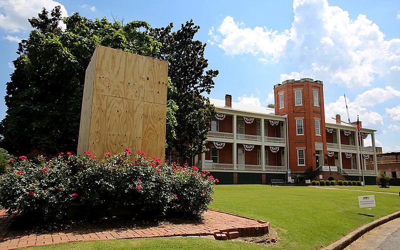 The Confederate monument outside the MacArthur Museum of Arkansas Military History in Little Rock was removed on Thursday, June 18, 2020, and the statue's pedestal has been boarded up after it was vandalized. See more photos at arkansasonline.com/619statue/ (Arkansas Democrat-Gazette/Thomas Metthe)