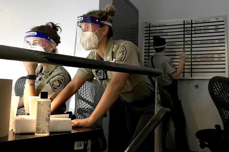 Sgt. Audrey Molen and Cpl. Alexis Bartholomew work Thursday at the Washington County Detention Center. The county reported 46 new coronavirus cases Thursday.
(Photo courtesty of the Washington County Sheriff’s Office)