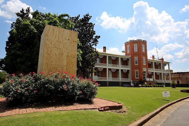 The Confederate monument outside the MacArthur Museum of Arkansas Military History in Little Rock was removed on Thursday and the statue’s pedestal boarded up after it was vandalized earlier in the week. More photos at arkansasonline.com/619statue/.
(Arkansas Democrat-Gazette/Thomas Metthe)