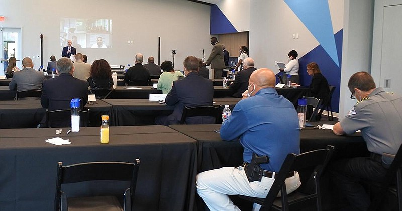 Members of the Task Force to Advance the State of Law Enforcement in Arkansas and others listen as Gov. Asa Hutchinson speaks Thursday at Fort Smith’s U.S. Marshals Museum during the task force’s first meeting.
(Arkansas Democrat-Gazette/Thomas Saccente)