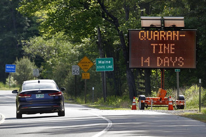 A sign in Gilead, Maine, near the border with New Hampshire, warns visitors entering Maine that they are required to quarantine for 14 days.
(AP/Robert F. Bukaty) story.lead_photo.caption
