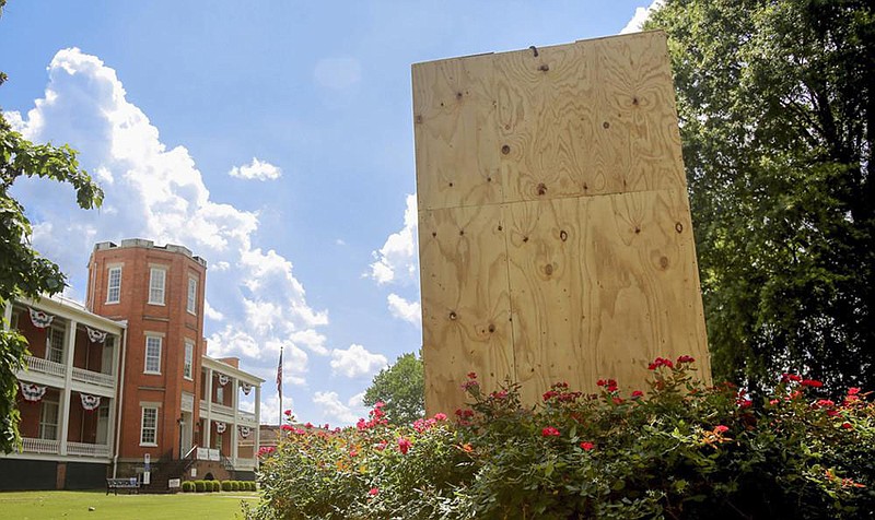 A Confederate monument outside the MacArthur Museum of Arkansas Military History in Little Rock was removed on Thursday and the statue’s pedestal has been boarded up after it was vandalized.
(Arkansas Democrat-Gazette/Thomas Metthe)