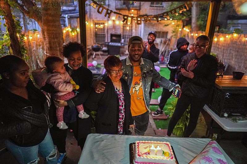 Wanda Coleman receives a hug from her grandson, Jevon Foster, before she blows out the candles at her 68th birthday celebration in Brooklyn, N.Y., on May 20. It was Coleman’s first birthday without her spouse of 49 years, who died of coronavirus.
(The New York Times/Chang W. Lee)