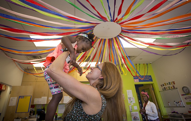 FILE — Then-executive director of Our House Georgia Mjartan plays with Our House Childrens Center student Porter Nelson during her daily rounds in 2017 at the shelter for working homeless families in Little Rock.