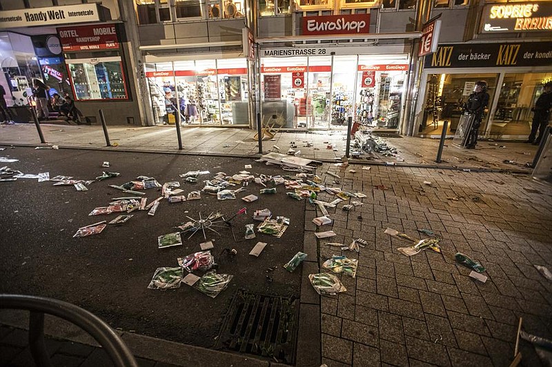 Goods are strewn on the street after vandals broke into a shop Sunday in Stuttgart, Germany. Video at arkansasonline. com/622stuttgart/. (AP/dpa/Simon Adomat) 
