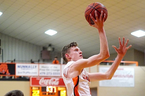 Westside Eagle Observer/RANDY MOLL Gravette sophomore Tristan Batie goes up for a shot in play against the visiting Berryville Bobcats on Friday in Lion Field House.
