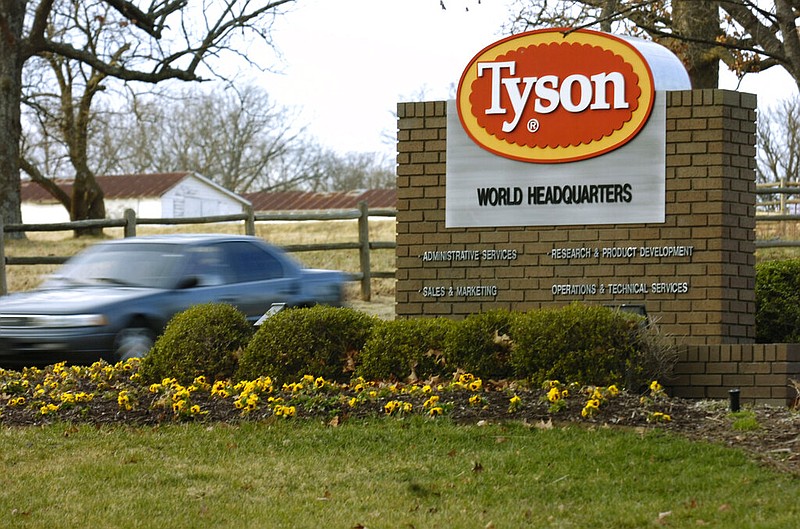 FILE - In this Jan. 29, 2006, file photo, a car passes in front of a Tyson Foods Inc., sign at Tyson headquarters in Springdale, Ark. China's decision to ban imports from a single Tyson Foods poultry plant because of concerns about a coronavirus outbreak there puzzled many in the meat industry and raised concerns about whether this could threaten a major market for U.S. meat. The action China's customs agency took against the Tyson plant in Springdale, Arkansas, could have major implications for the meat industry if it were expanded because dozens of beef, pork and poultry plants have had outbreaks of the coronavirus among their workers.(AP Photo/April L. Brown, File)

