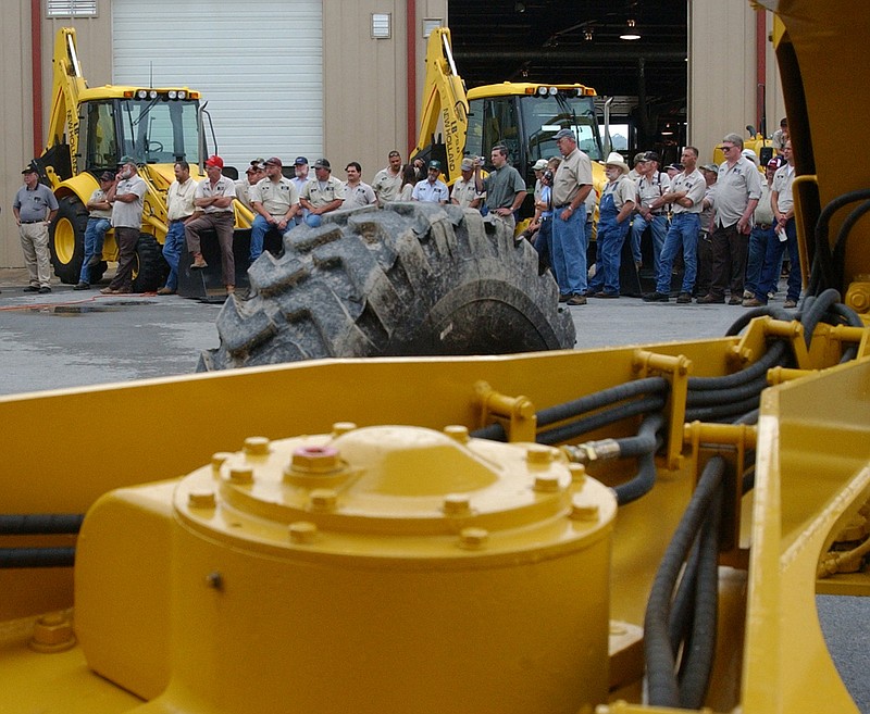 Washington County Road and Bridge Department operators attend a ceremony introducing newly purchased equipment at the department in Fayetteville. (NWA Democrat-Gazette/FILE PHOTO)
