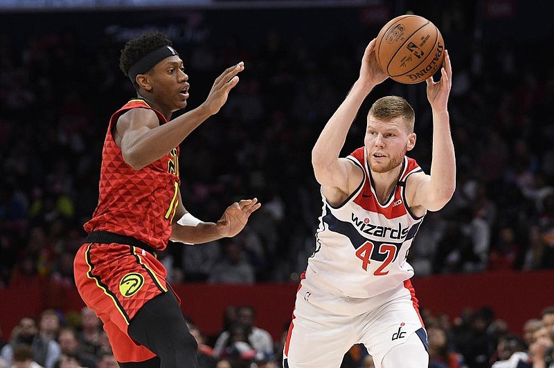 Washington Wizards forward Davis Bertans (right) will skip the Orlando-based resumption of the NBA season. He is the rst known example of a healthy, eligible player who is sitting out. (AP/Nick Wass) 