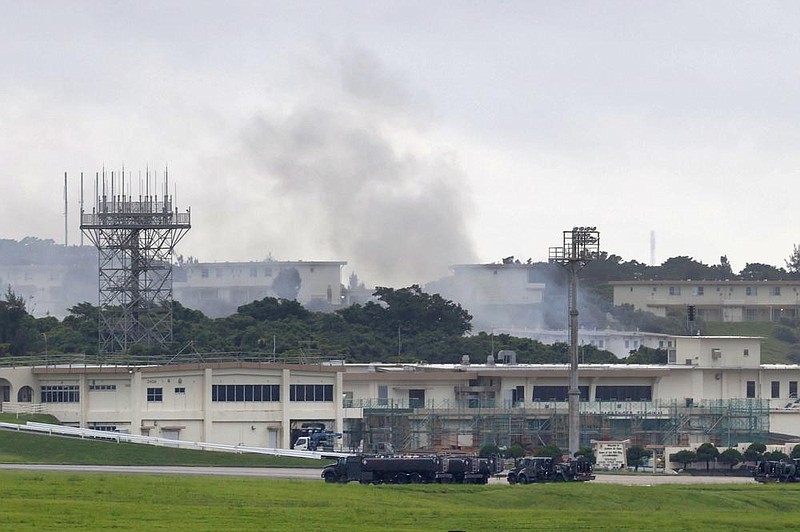 Smoke rises Monday morning from the 18th Wing Hazardous Materials Pharmacy building at Kadena Air Base on the island of Okinawa, Japan. The cause of the fire is still unknown, the U.S. Air Force said. 
(AP/Kyodo News) 
