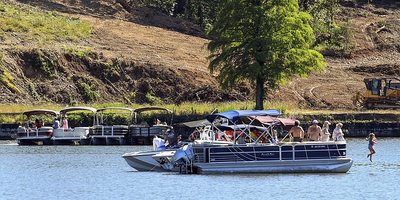 Groups of boaters enjoy the summer-like weather on Lake Hamilton on May 30. - Photo by Grace Brown of The Sentinel-Record