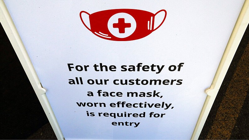 In this Tuesday, June 23, 2020, photo, a "Face Covering" sign is shown at Snider Bros. Meats, in Holladay, Utah. (AP Photo/Rick Bowmer)
story.lead_photo.caption