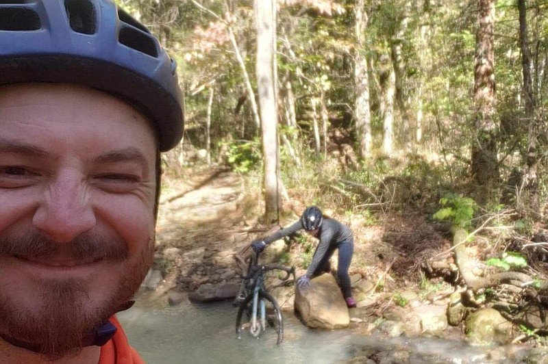 The mischievous grin says it all as Justin Parcell watches Andrea Nevil attempt to cross a creek on a cycling outing. Parcell, 34, died in a kayaking accident on the King's River in May. 
Courtesy photo Andrea Nevil