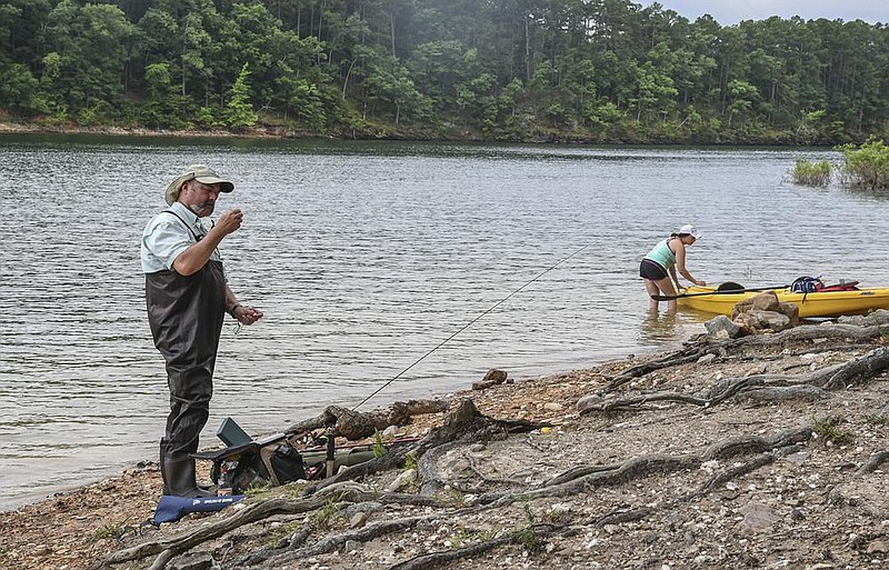 Keith Romero and Jessica Calhoun get their fishing equipment ready Sunday along the banks of Lake Ouachita in Lake Ouachita State Park.
(The Sentinel-Record/Grace Brown)