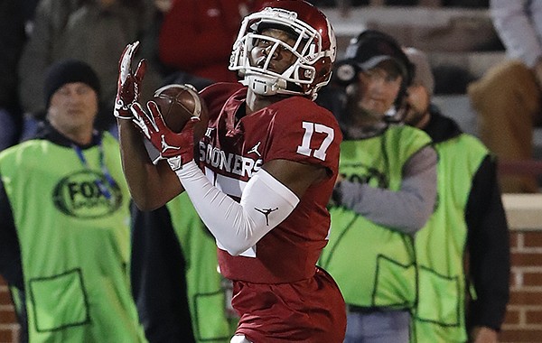 Oklahoma wide receiver Jaquayln Crawford (17) makes a catch during warm ups before the start of an NCAA college football game against Kansas in Norman, Okla., Saturday, Nov. 17, 2018. (AP Photo/Alonzo Adams)