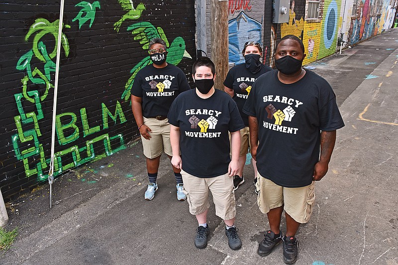 Organizers of the Searcy Movement stand in front of a “Black Lives Matter” mural in downtown Searcy. In the front row are Lydia Bumpous, left, and Leroy Sanders; and in the back row are Shantel Davis, left, and Shamra Selms.