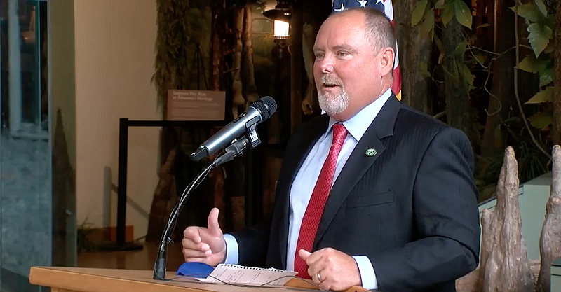 Rob Finley, 54, of Mountain Home speaks at the Witt Stephens Jr. Central Arkansas Nature Center in Little Rock on Friday in this still of video provided by the governor's office. 