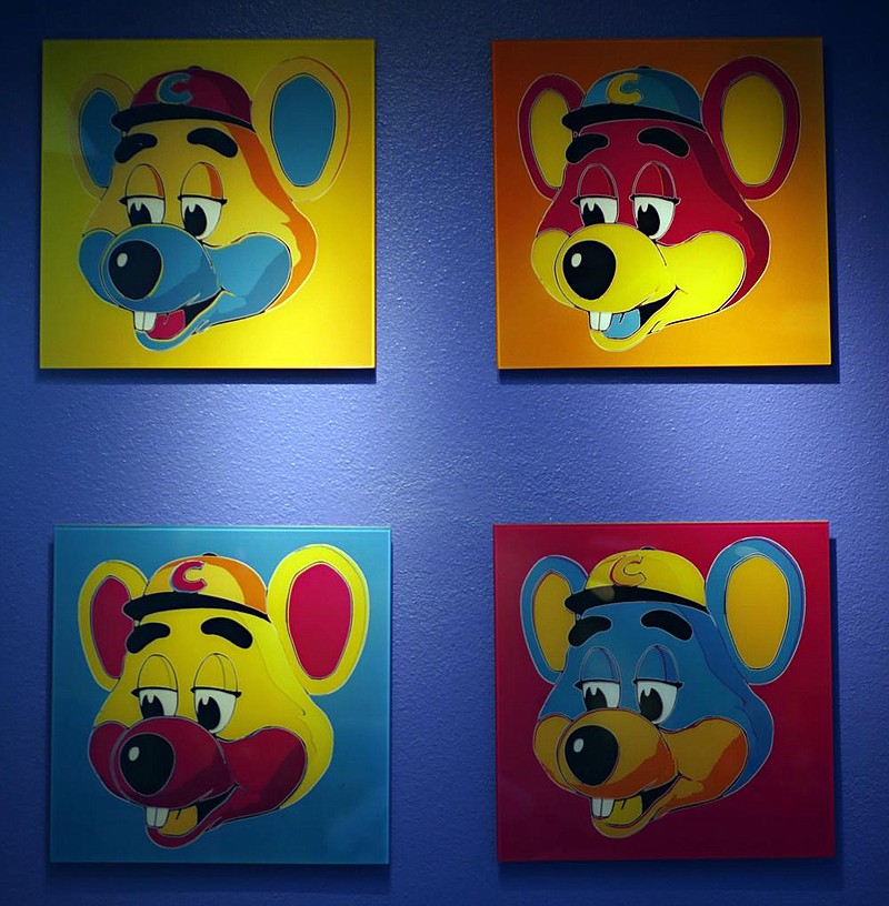 Paintings of Chuck E. Cheese hang on a wall of a franchise in Dallas in this file photo. Chuck E. Cheese pizzeria has filed for bankruptcy protection.
(The Dallas Morning News/G.J. McCarthy)